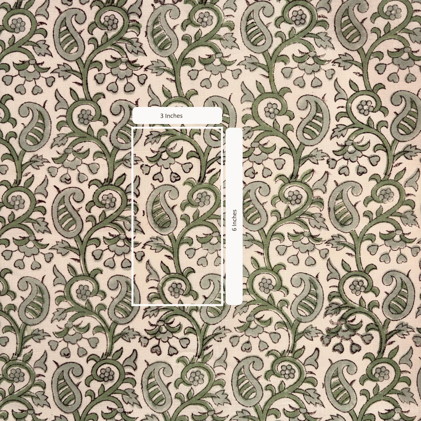 Patterned fabric with green and beige design, featuring a measurement overlay.