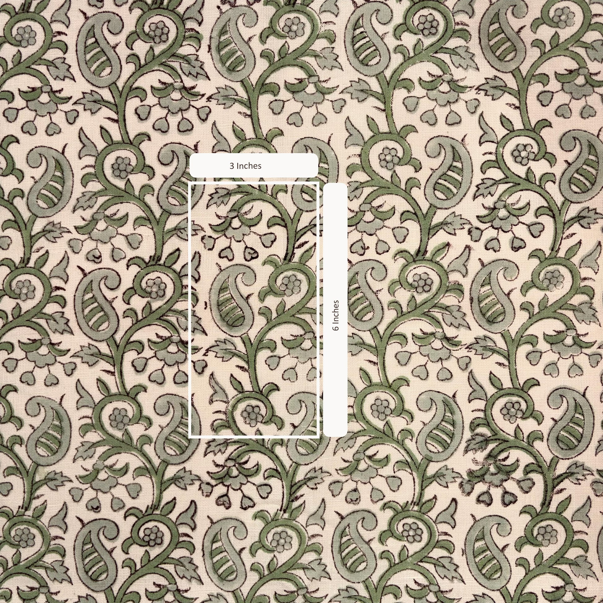 Patterned fabric with green and beige design, featuring a measurement overlay.