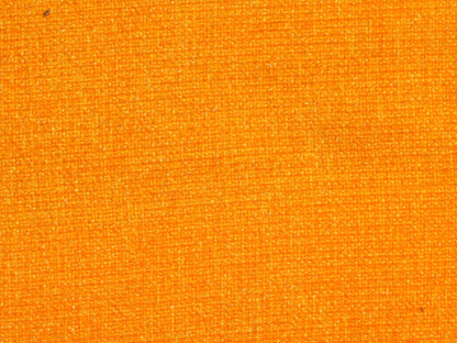 Close-up of a textured mustard fabric surface