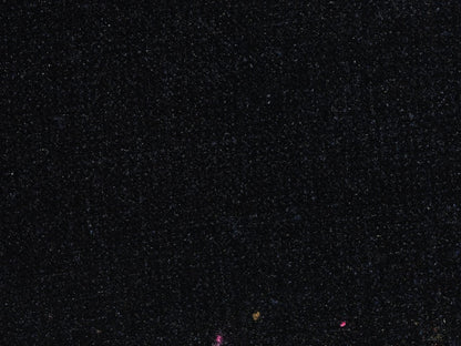 Dark textured surface with small colored spots