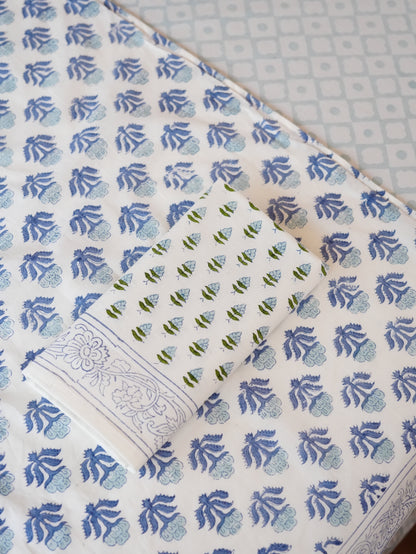 Patterned table runner with blue floral design with a napkin and tablecloth