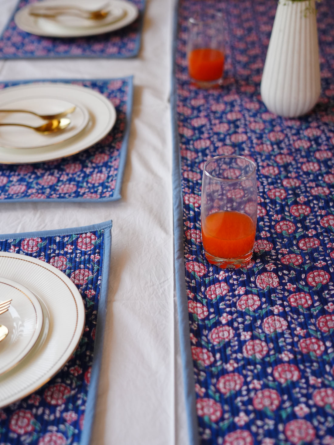 Table setting with floral table runner and placemats