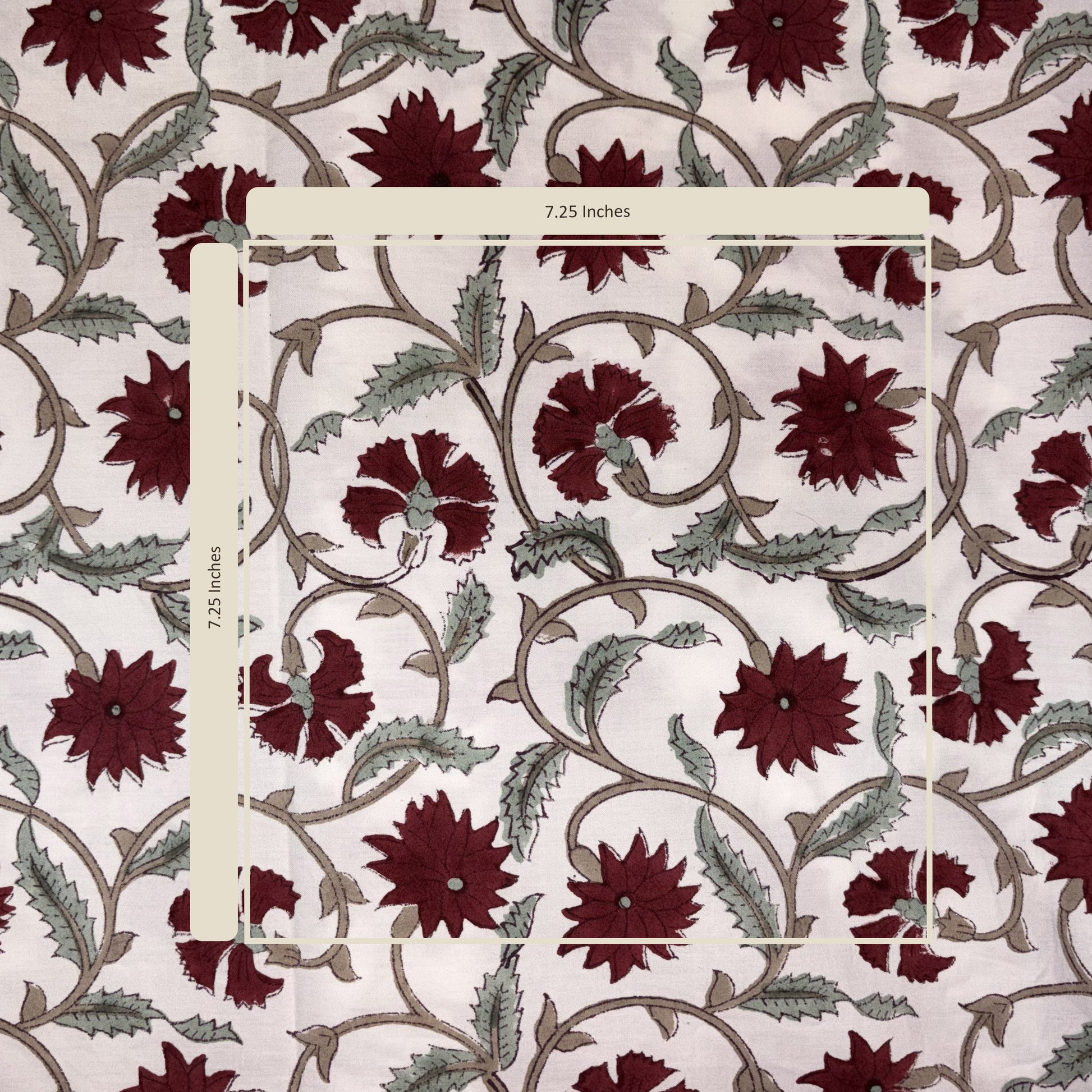 Fabric swatch with maroon floral pattern on a white background