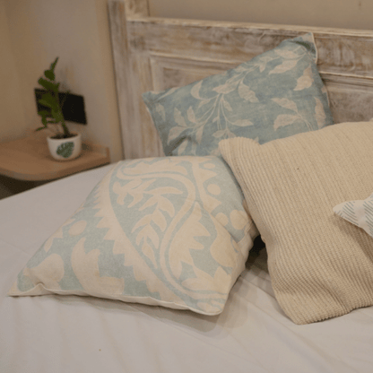 Decorative pillows on a bed with a rustic headboard
