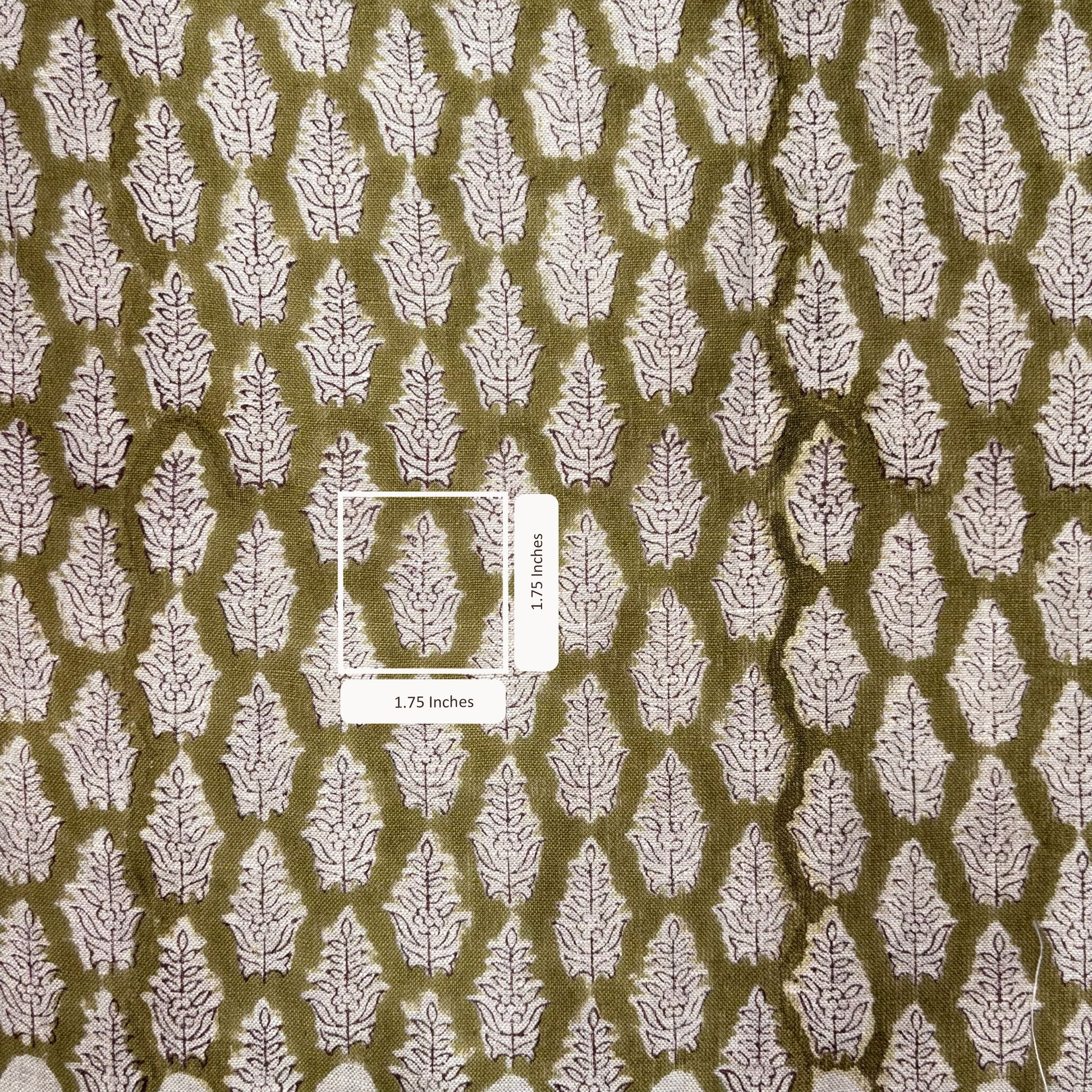 Fabric with white leaf pattern on a brown background, featuring a measurement label.
