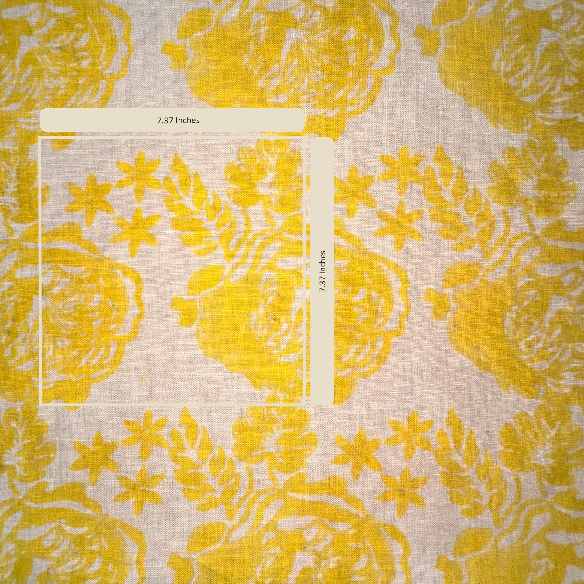 Yellow floral patterned fabric with a ruler for scale on a light background