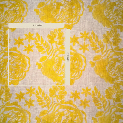 Yellow floral patterned fabric with a ruler for scale on a light background