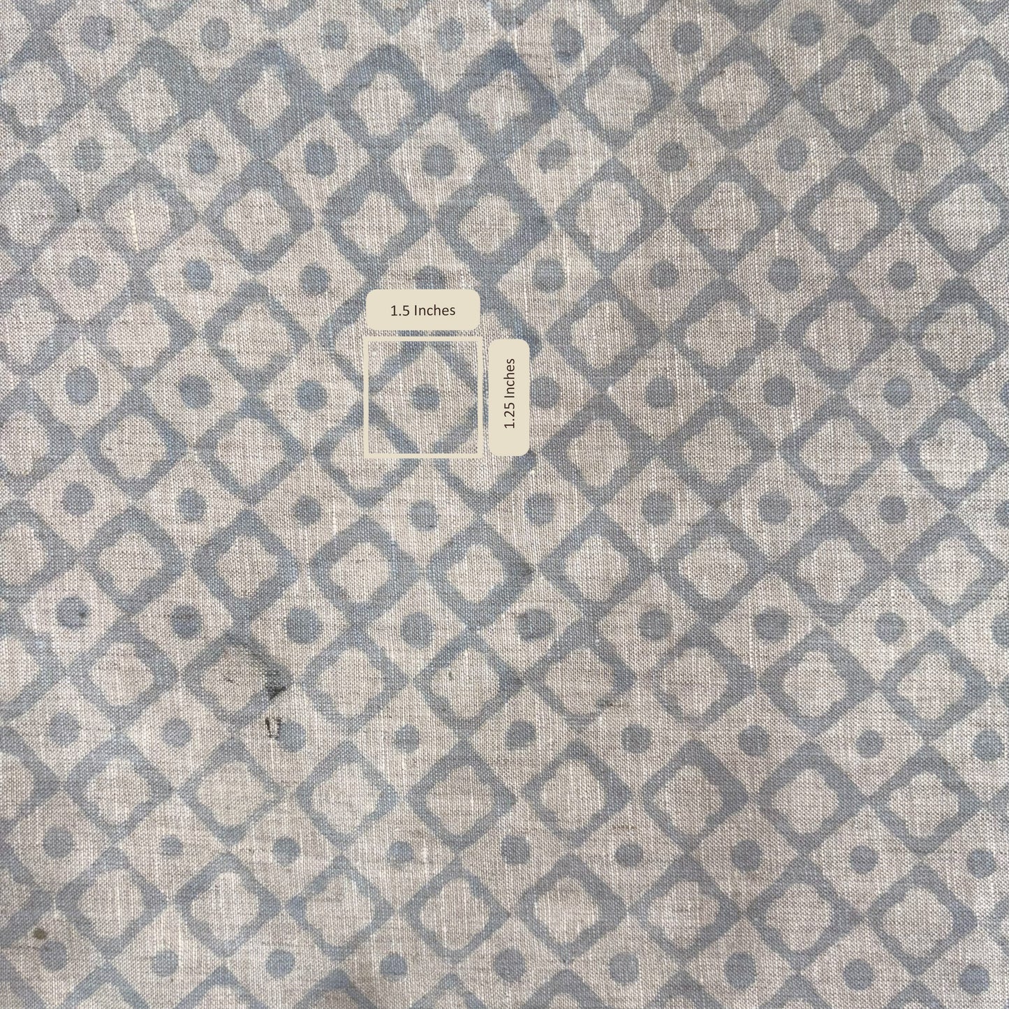 Textile with geometric pattern of squares and circles on a gray background with measurement scale