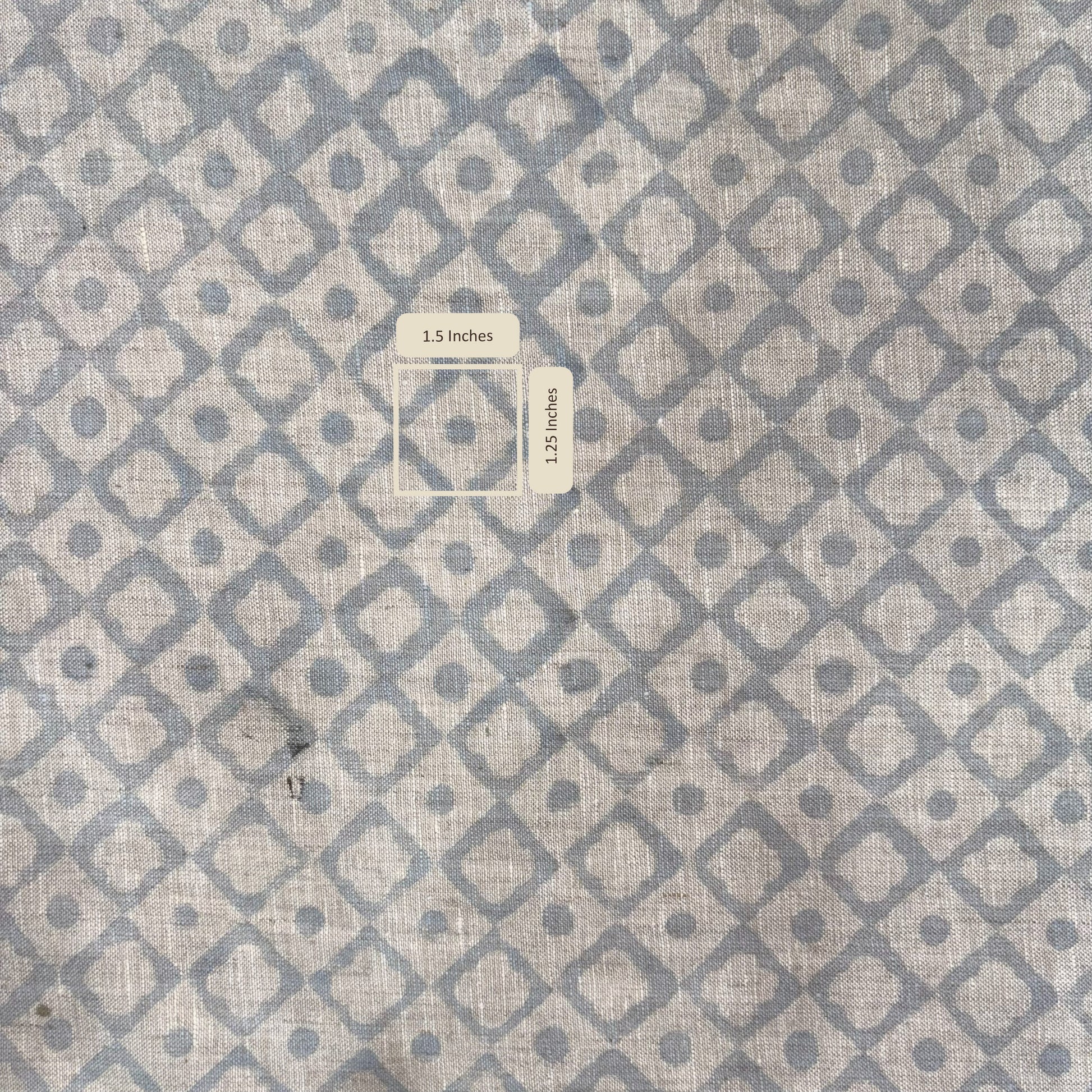Textile with geometric pattern of squares and circles on a gray background with measurement scale