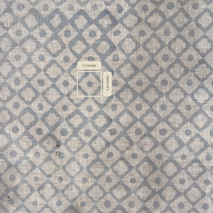 Textile with geometric pattern of squares and circles on a gray background with measurement scale