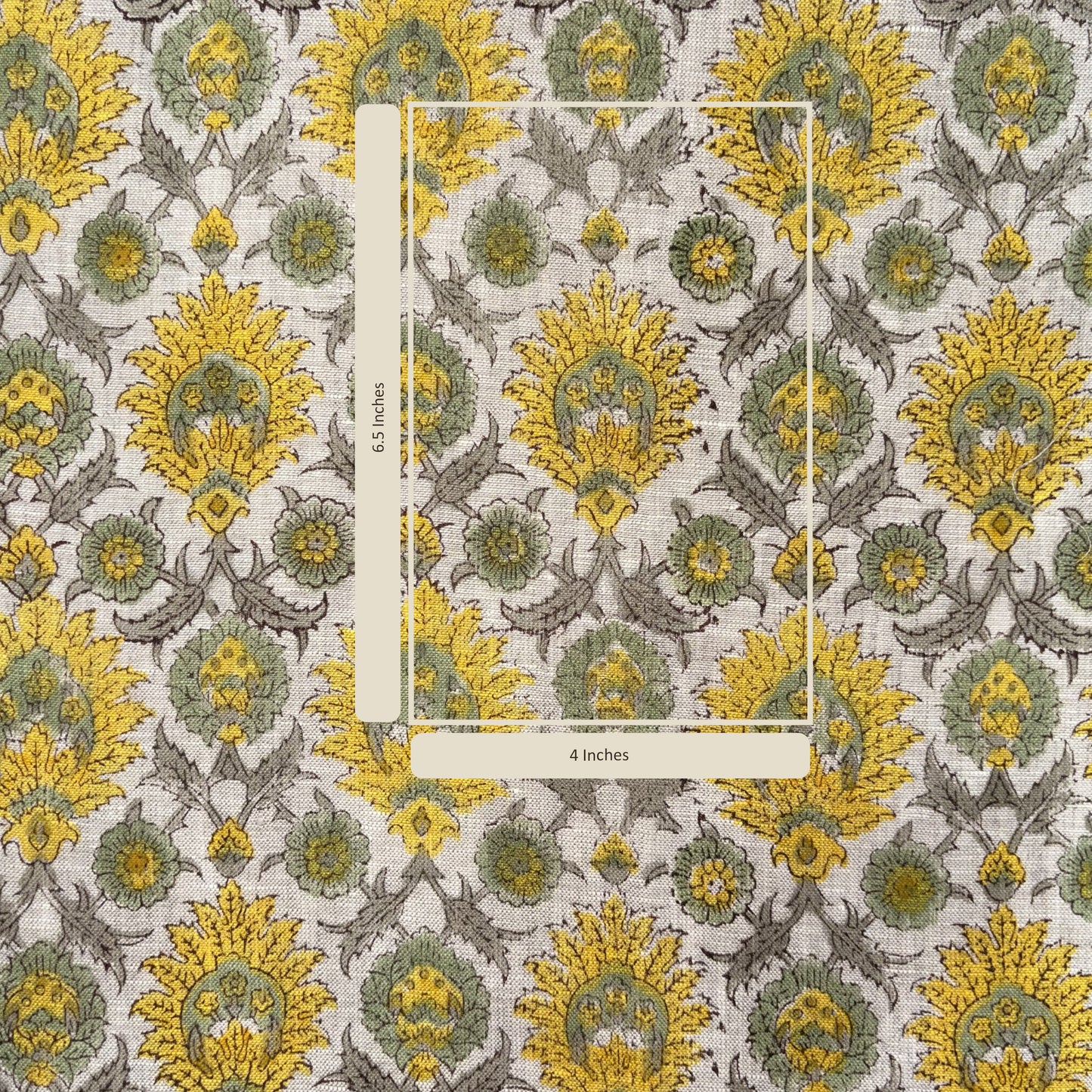 Decorative fabric with yellow and green floral pattern, featuring a ruler for scale.
