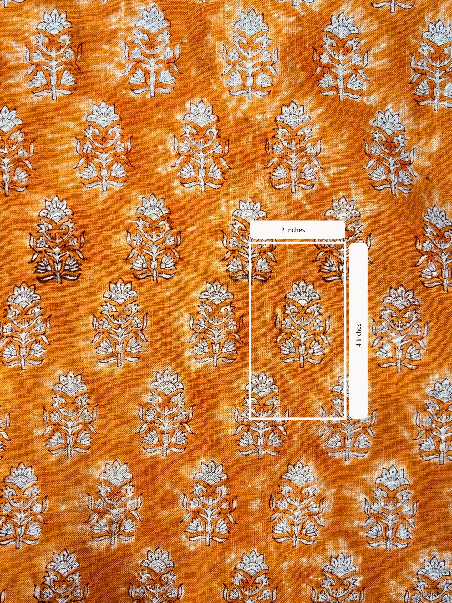Patterned fabric with floral design on an orange background