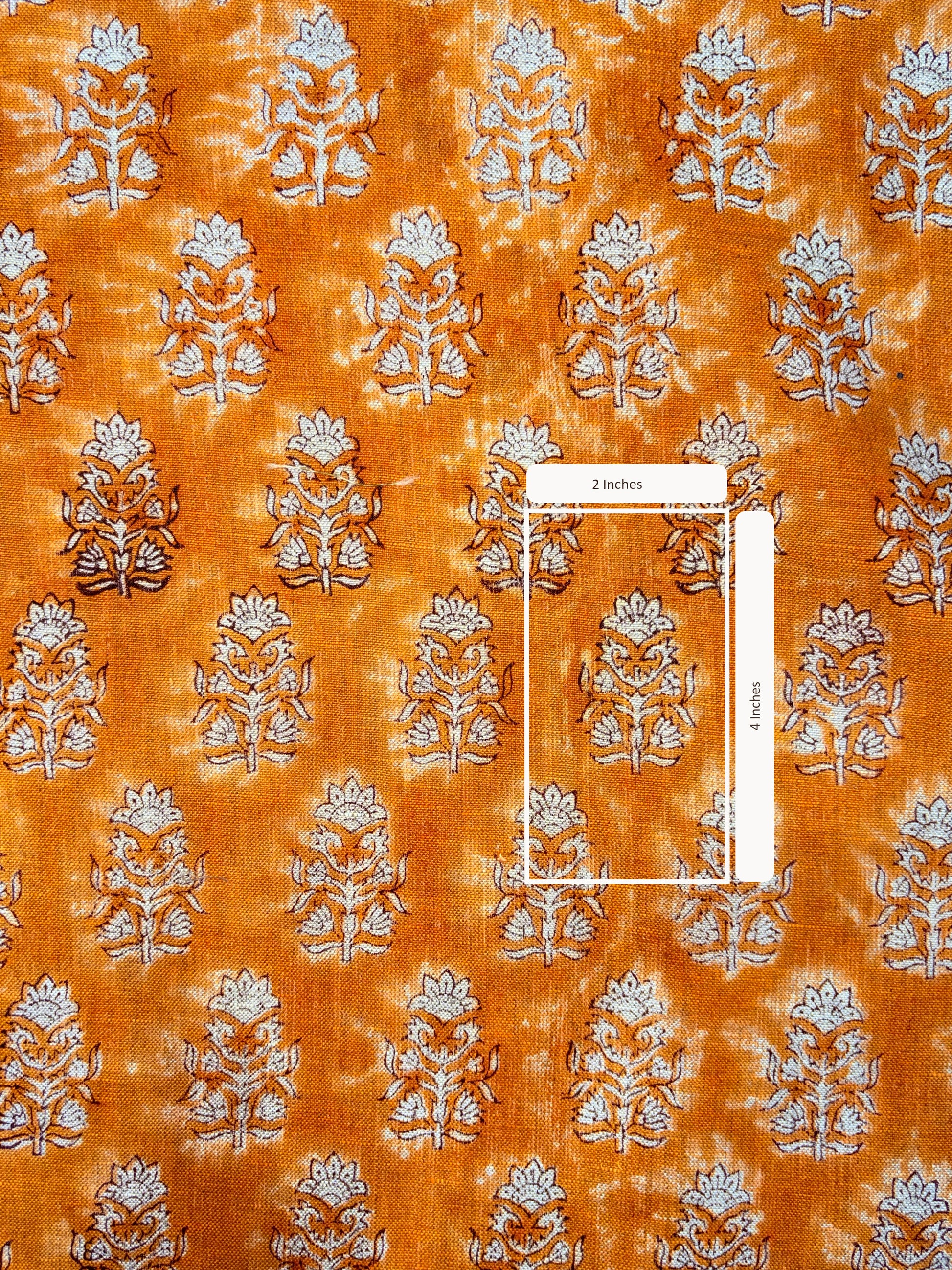 Patterned fabric with floral design on an orange background