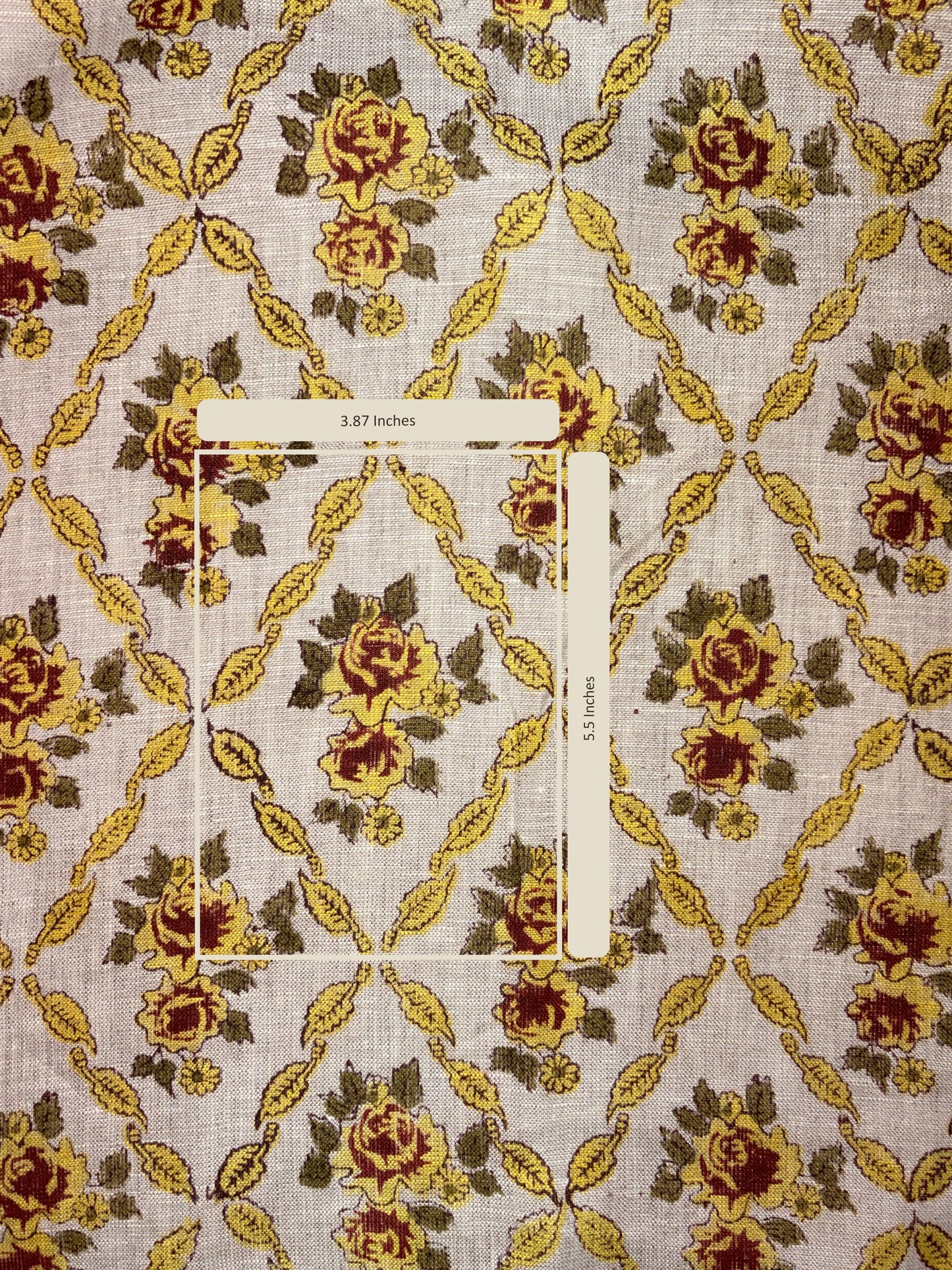 Fabric with floral pattern and a measuring tape for scale on a textured background