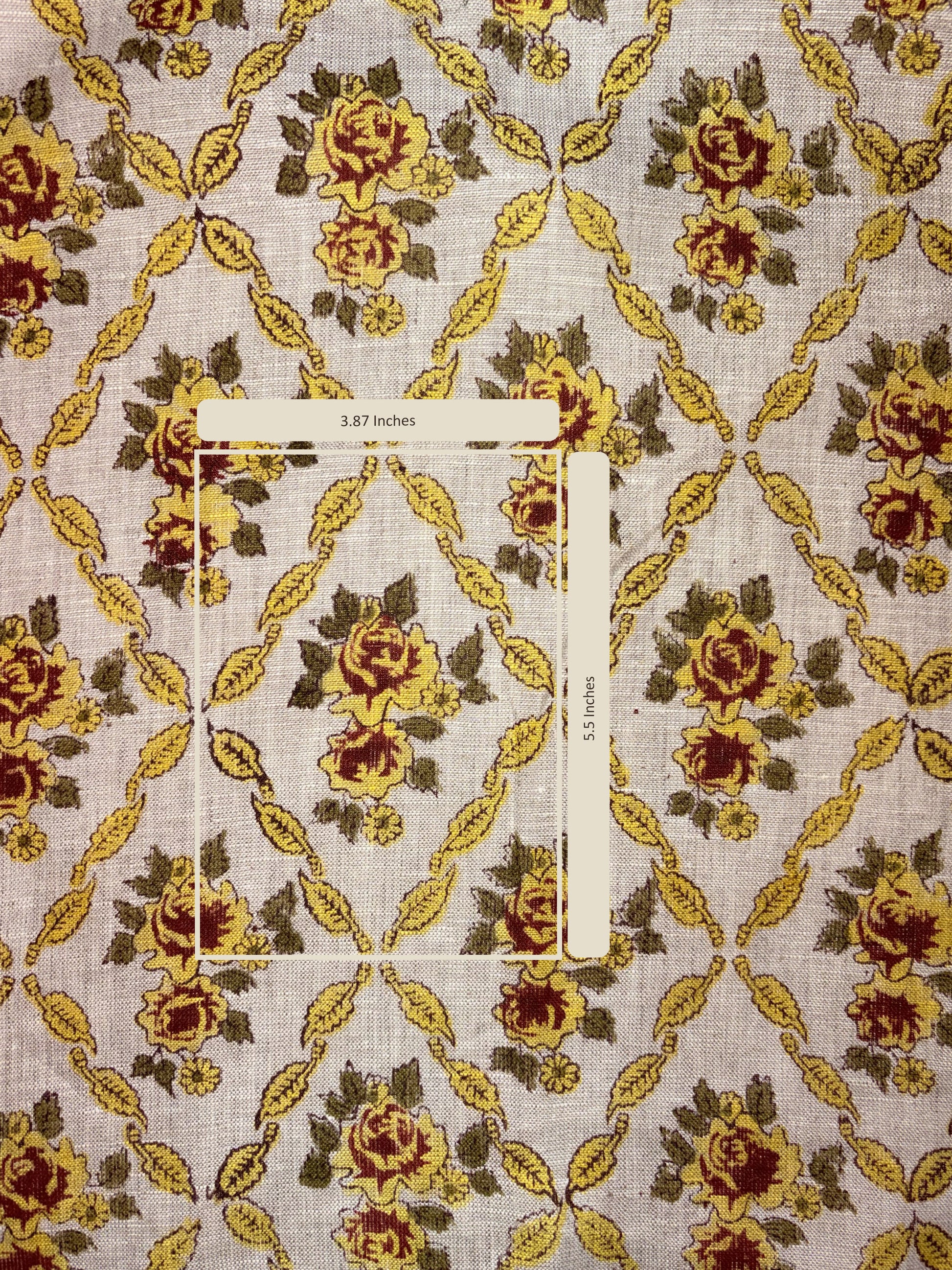 Fabric with floral pattern and a measuring tape for scale on a textured background