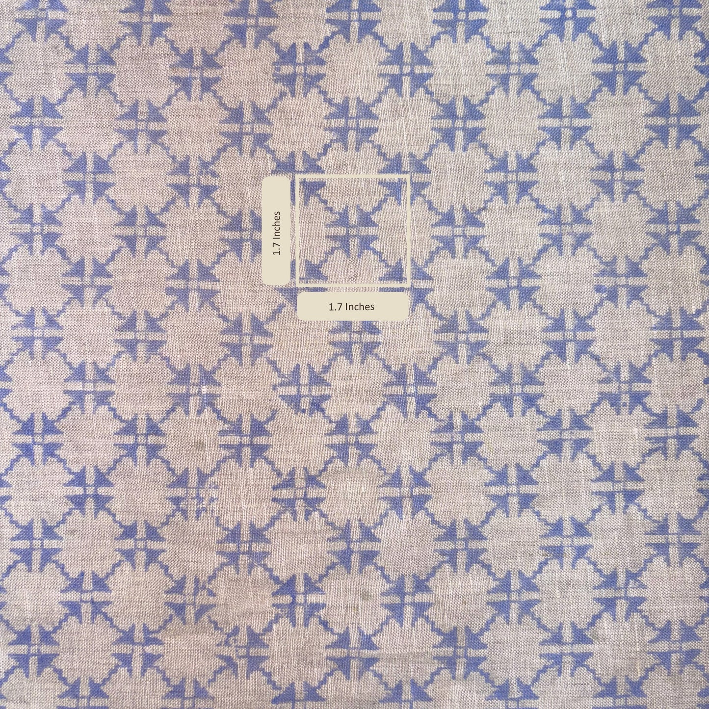 Fabric with blue and beige geometric pattern and measurement label.