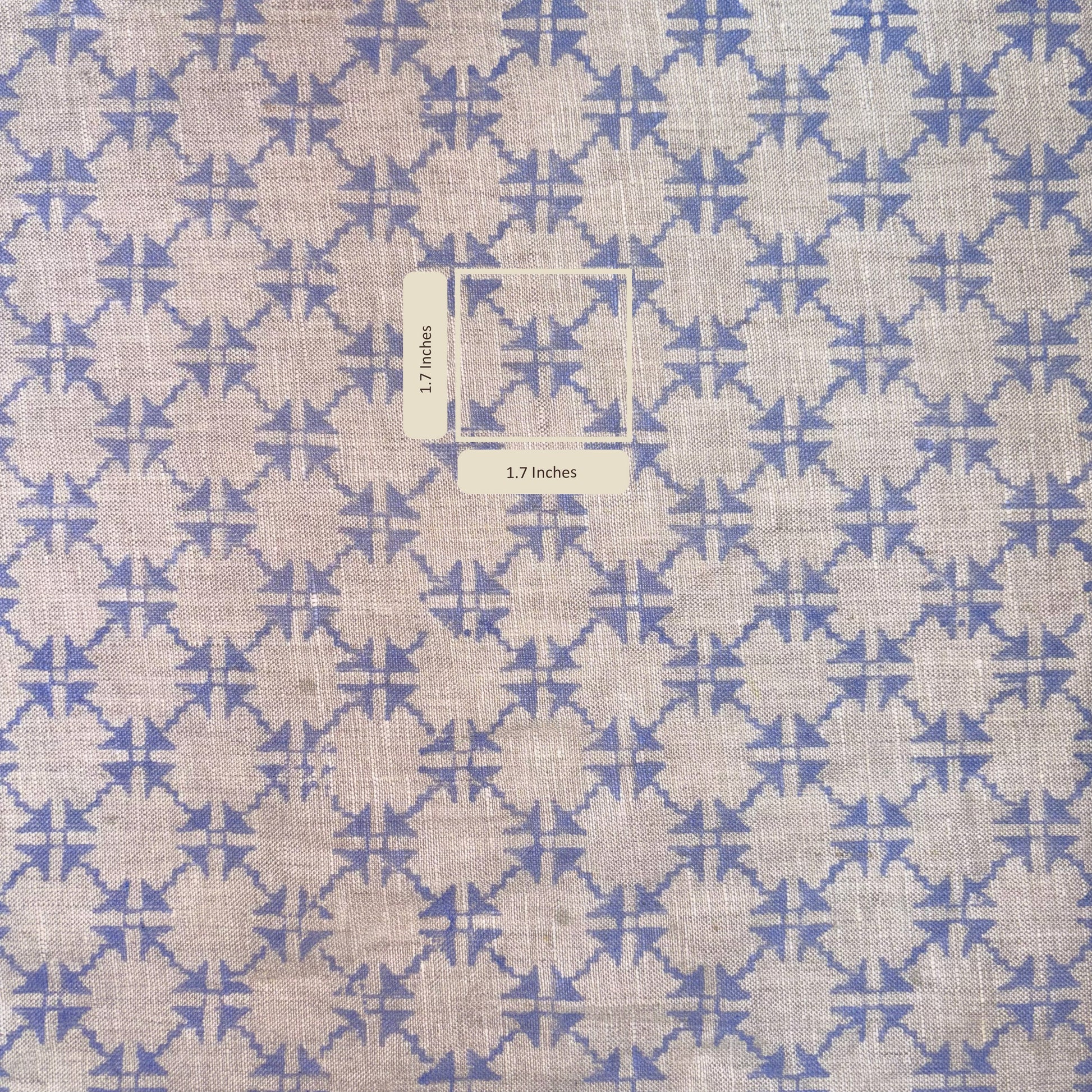Fabric with blue and beige geometric pattern and measurement label.