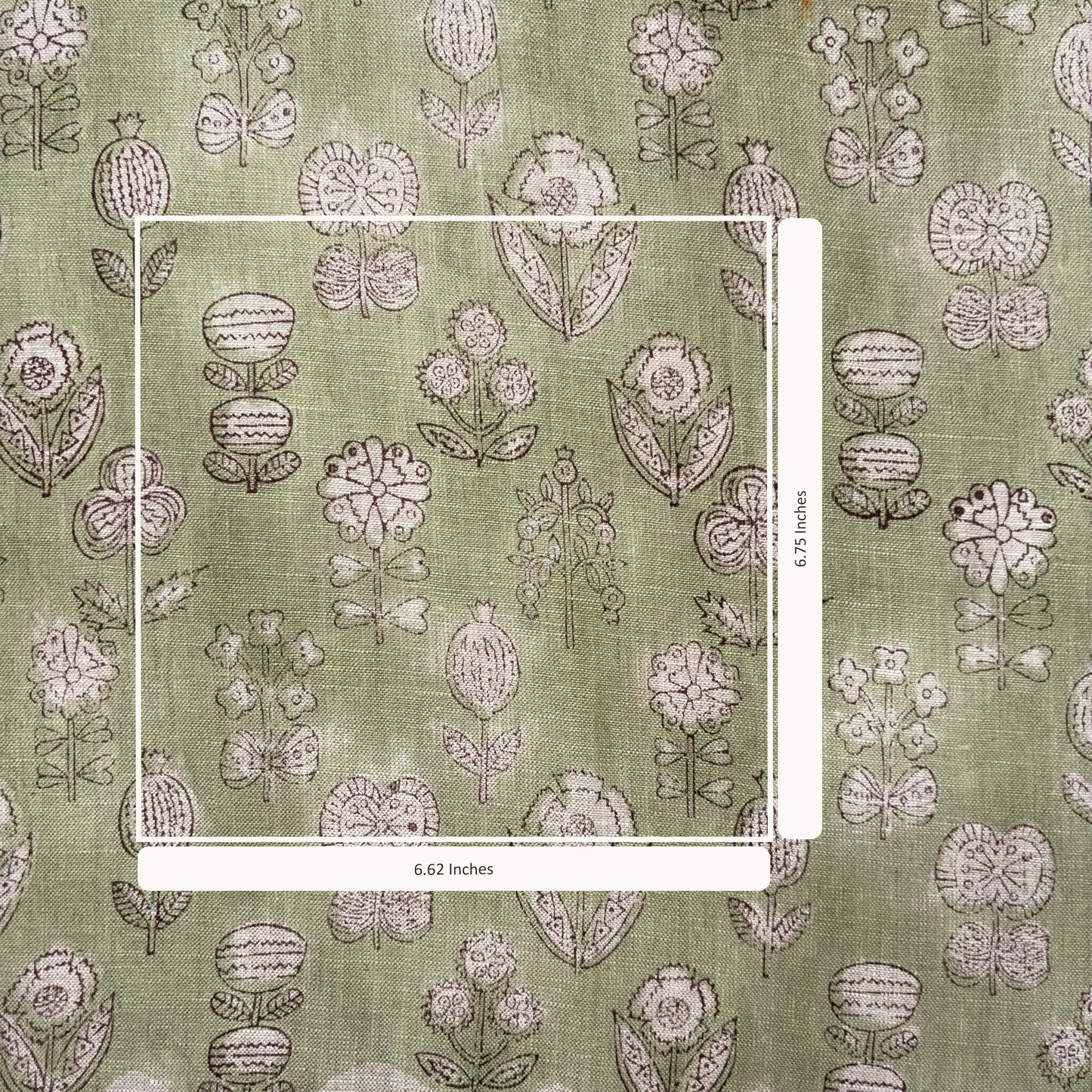 Floral patterned fabric with a ruler for scale on a green background