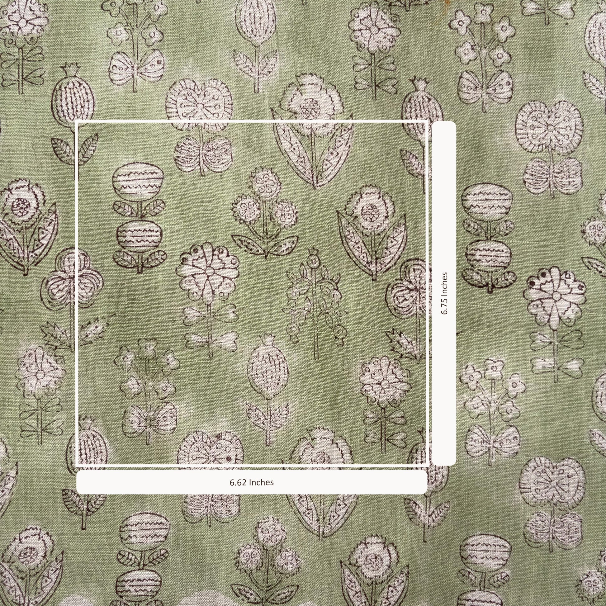Floral patterned fabric with a ruler for scale on a green background