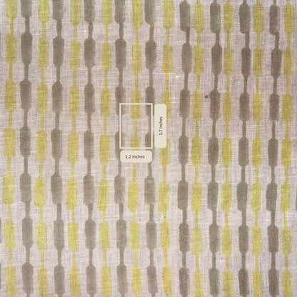 Fabric swatch with a geometric pattern in brown and yellow on a gray background