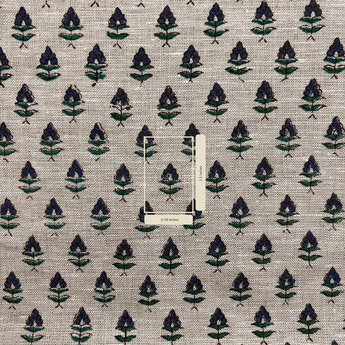 Textile fabric with a leaf pattern on a grey background with measurement scale