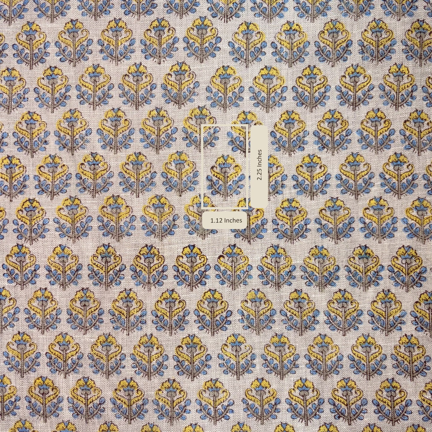 Patterned fabric with blue and yellow design on a grey background