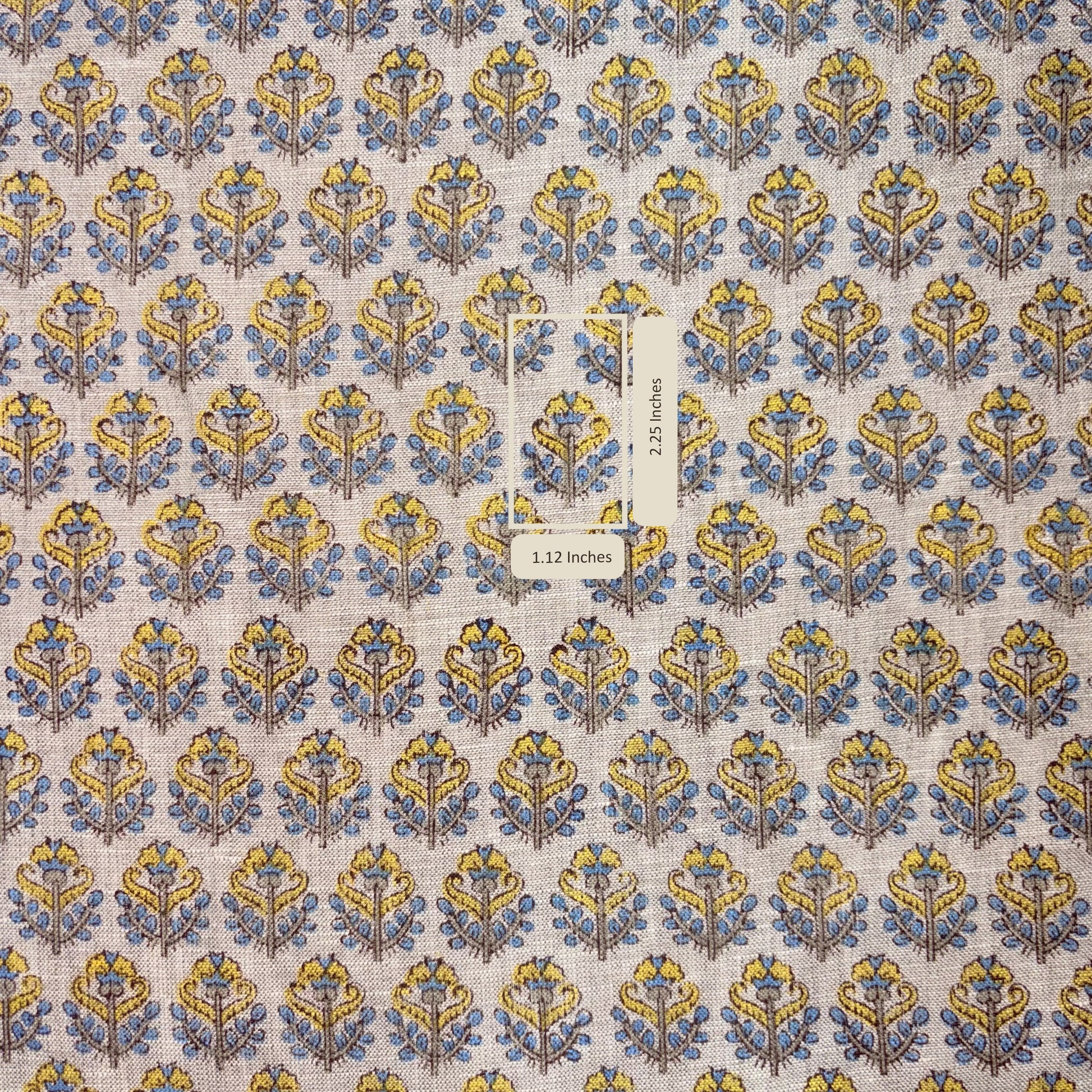 Patterned fabric with blue and yellow design on a grey background
