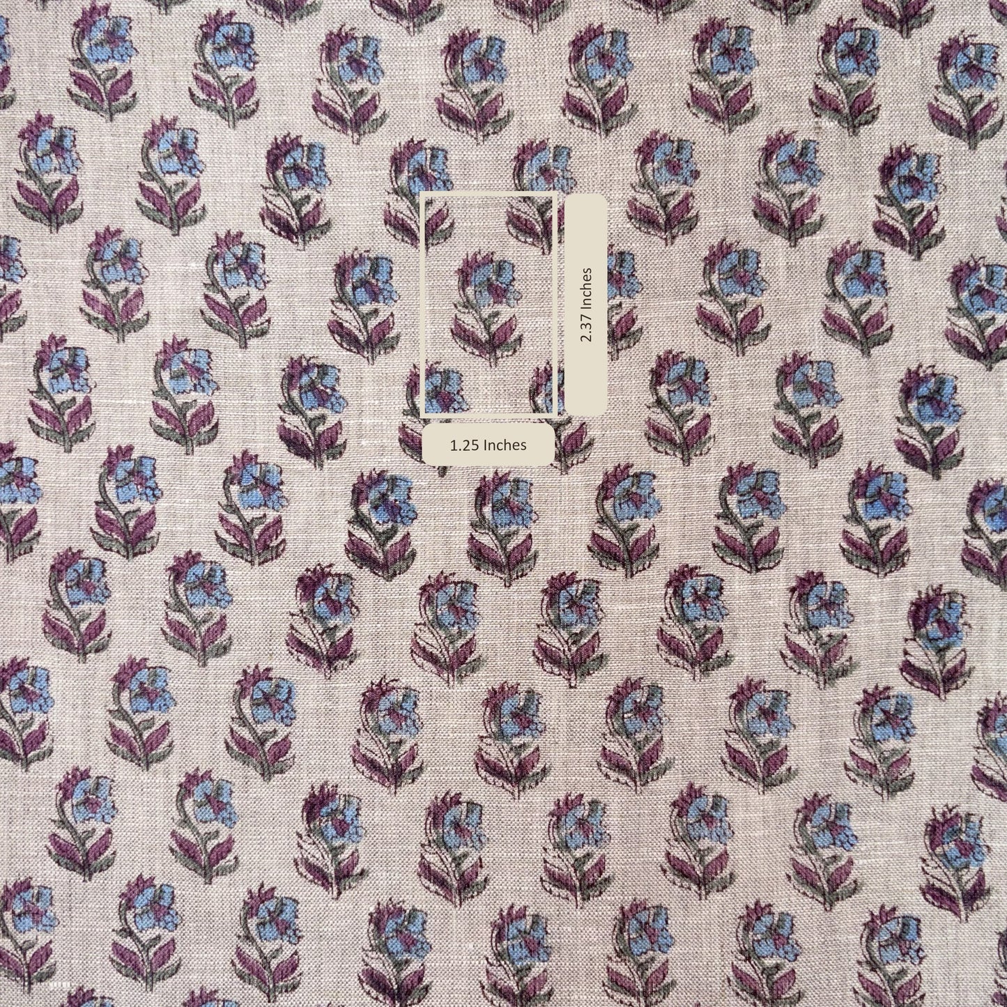 Floral patterned fabric with a label on a grey background