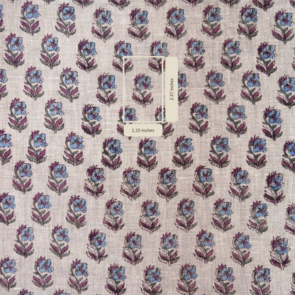 Floral patterned fabric with a label on a grey background