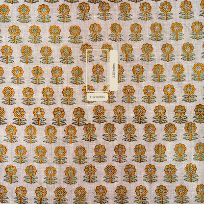Patterned fabric with orange and green flowers on a grey background