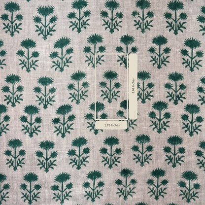 Patterned fabric with green floral design on grey background