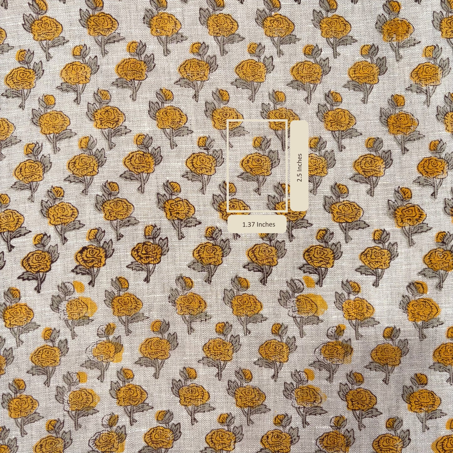 Fabric with yellow floral pattern and a label on a grey background