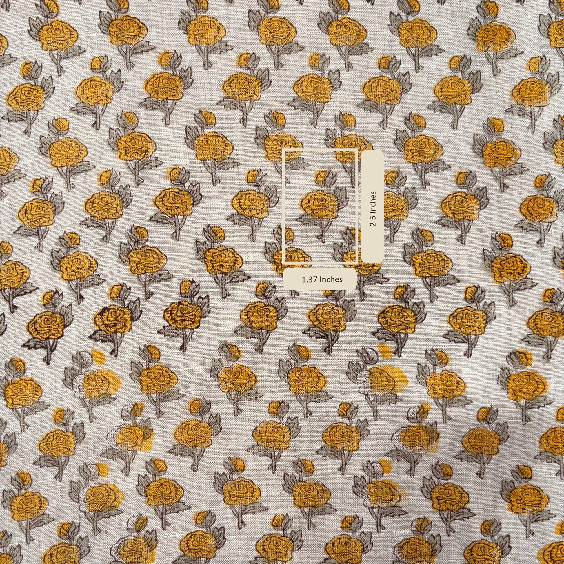 Fabric with yellow floral pattern and a label on a grey background