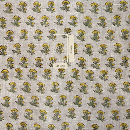 Fabric with yellow and green floral pattern on a gray background