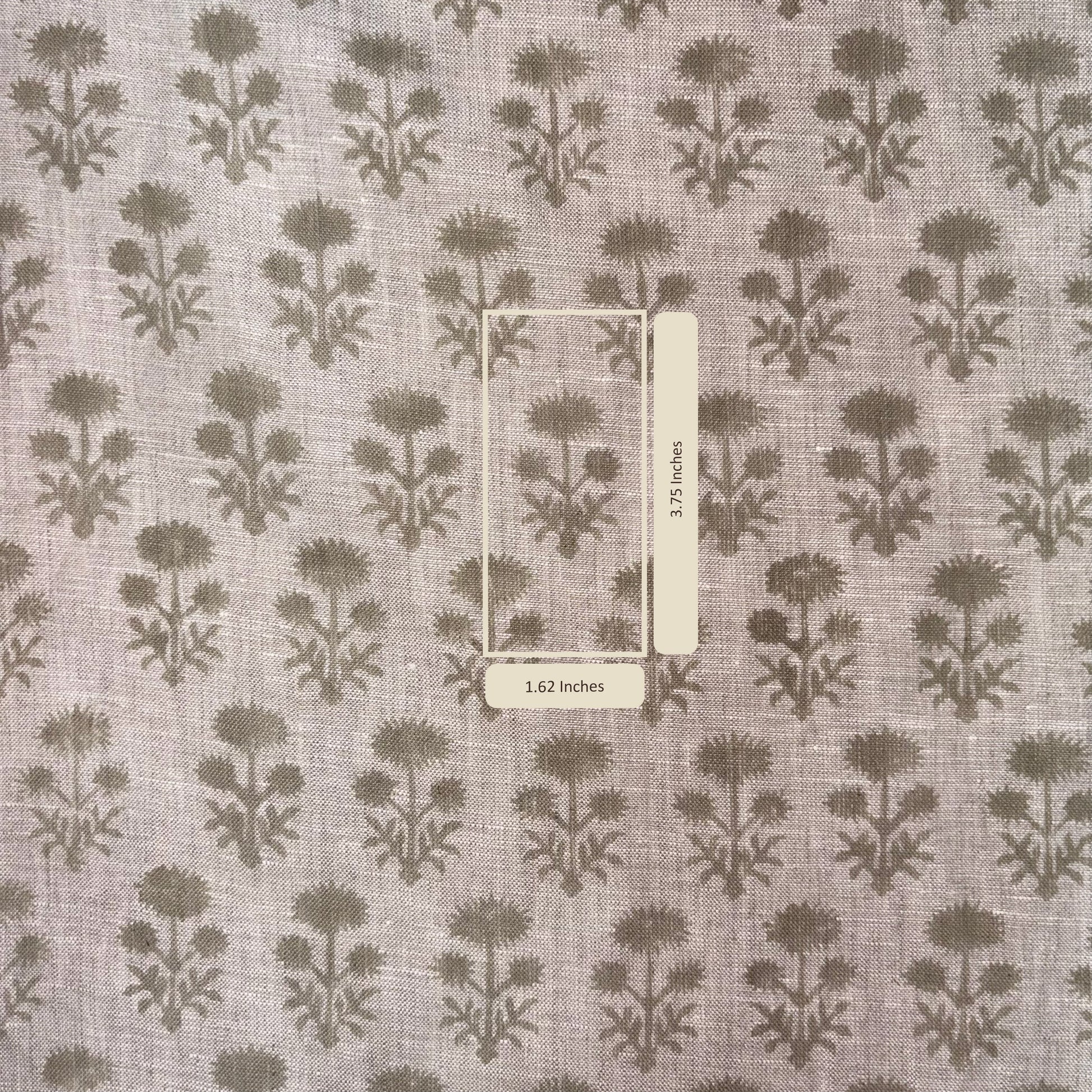 Fabric with a floral pattern and a ruler for scale on a gray background