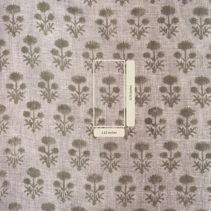 Fabric with a floral pattern and a ruler for scale on a gray background