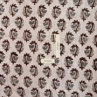 Fabric with a pattern of leaf-like shapes on a grey background, with a measurement label included.