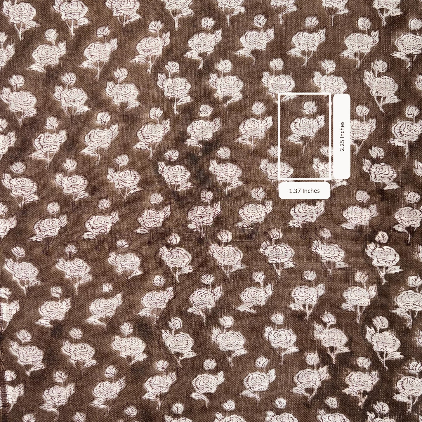 Brown fabric with white floral pattern and a measurement label.