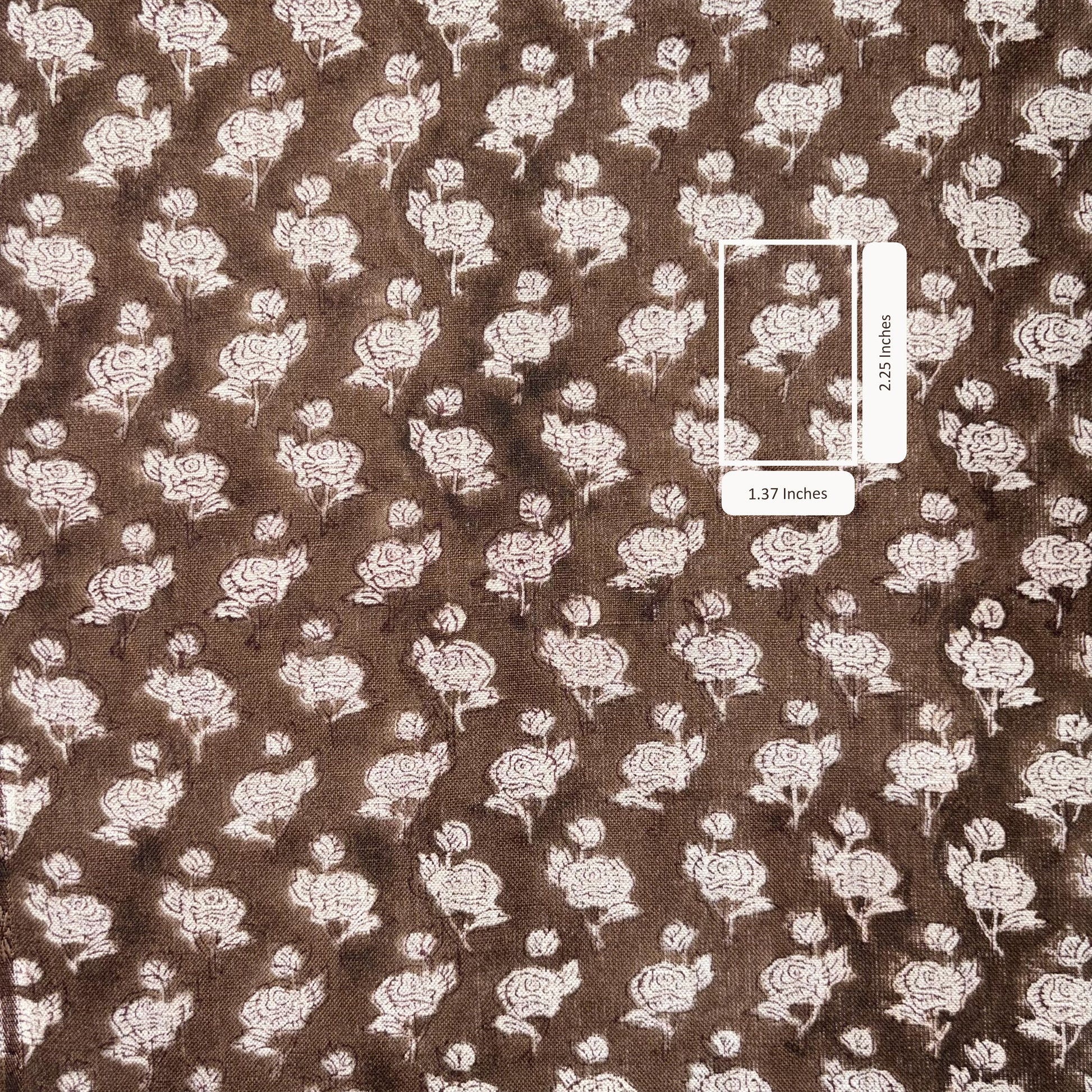 Brown fabric with white floral pattern and a measurement label.
