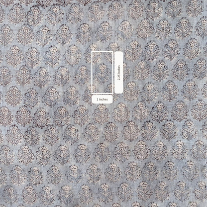 Patterned fabric with a small sample showing scale.