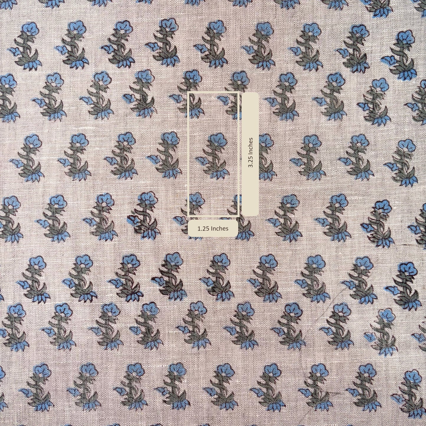Floral patterned fabric with a scale bar indicating measurements.