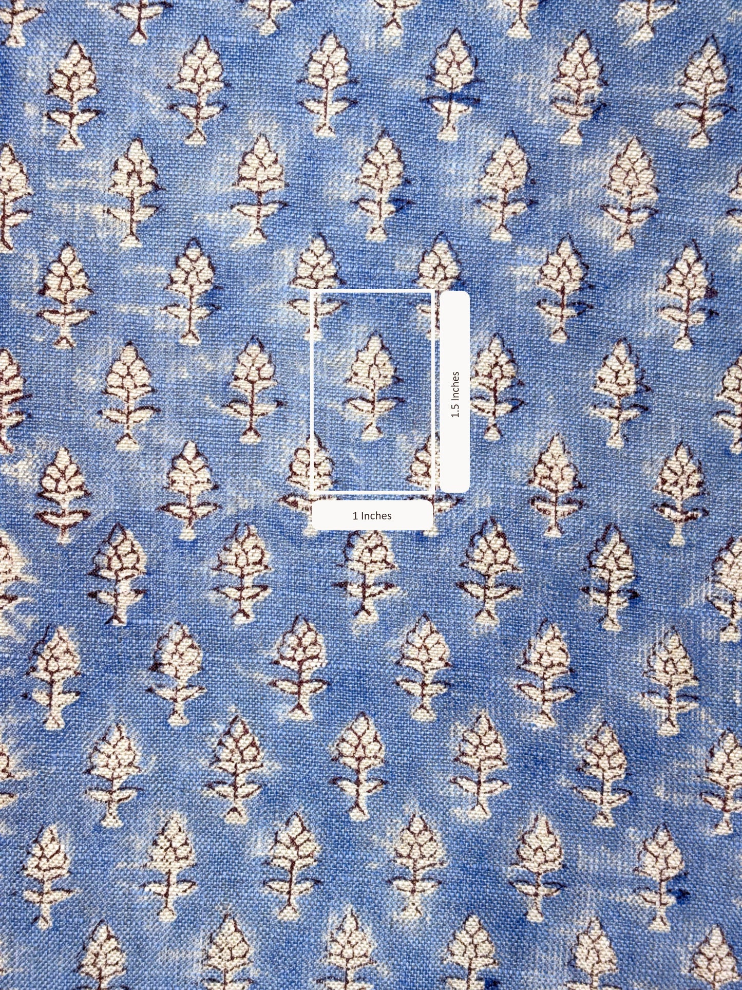 Blue fabric with white floral pattern with measurement scale