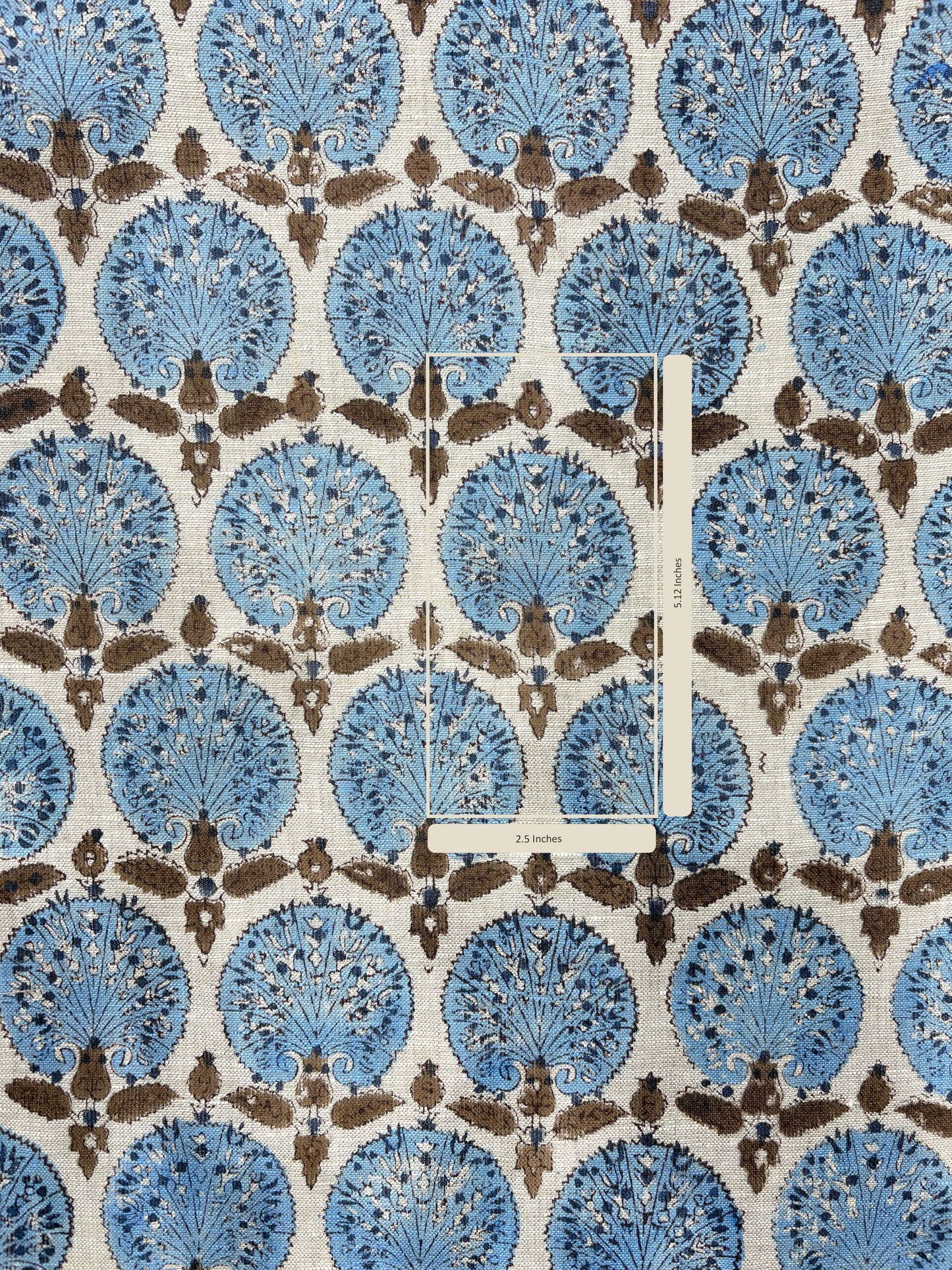 Patterned fabric with blue and brown design on a white background