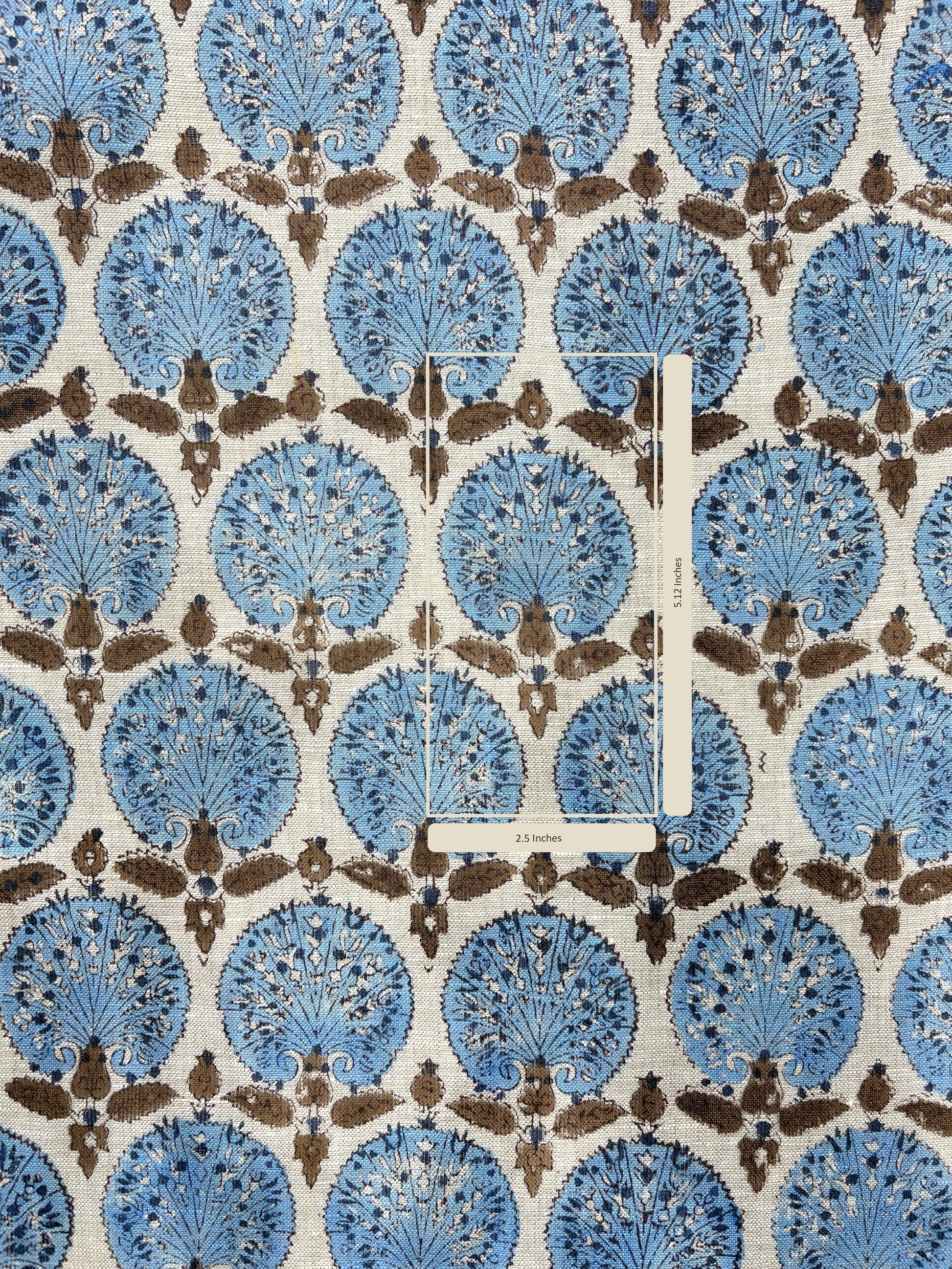 Patterned fabric with blue and brown design on a white background