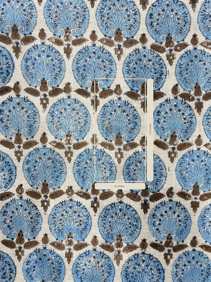 Patterned fabric with blue and brown design on a white background