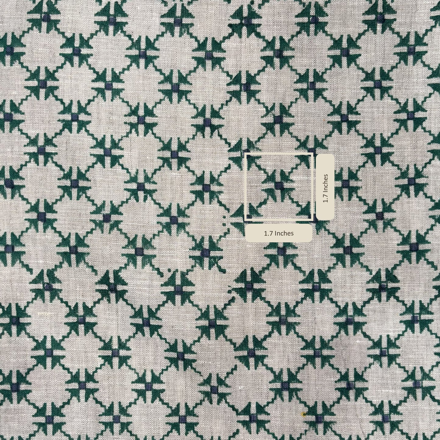 Fabric with a green and white geometric pattern and a label indicating dimensions.