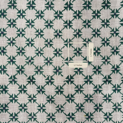 Fabric with a green and white geometric pattern and a label indicating dimensions.