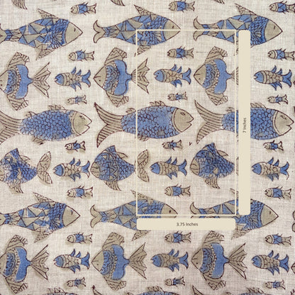 Patterned fabric with fish design and a ruler for scale on a grey background