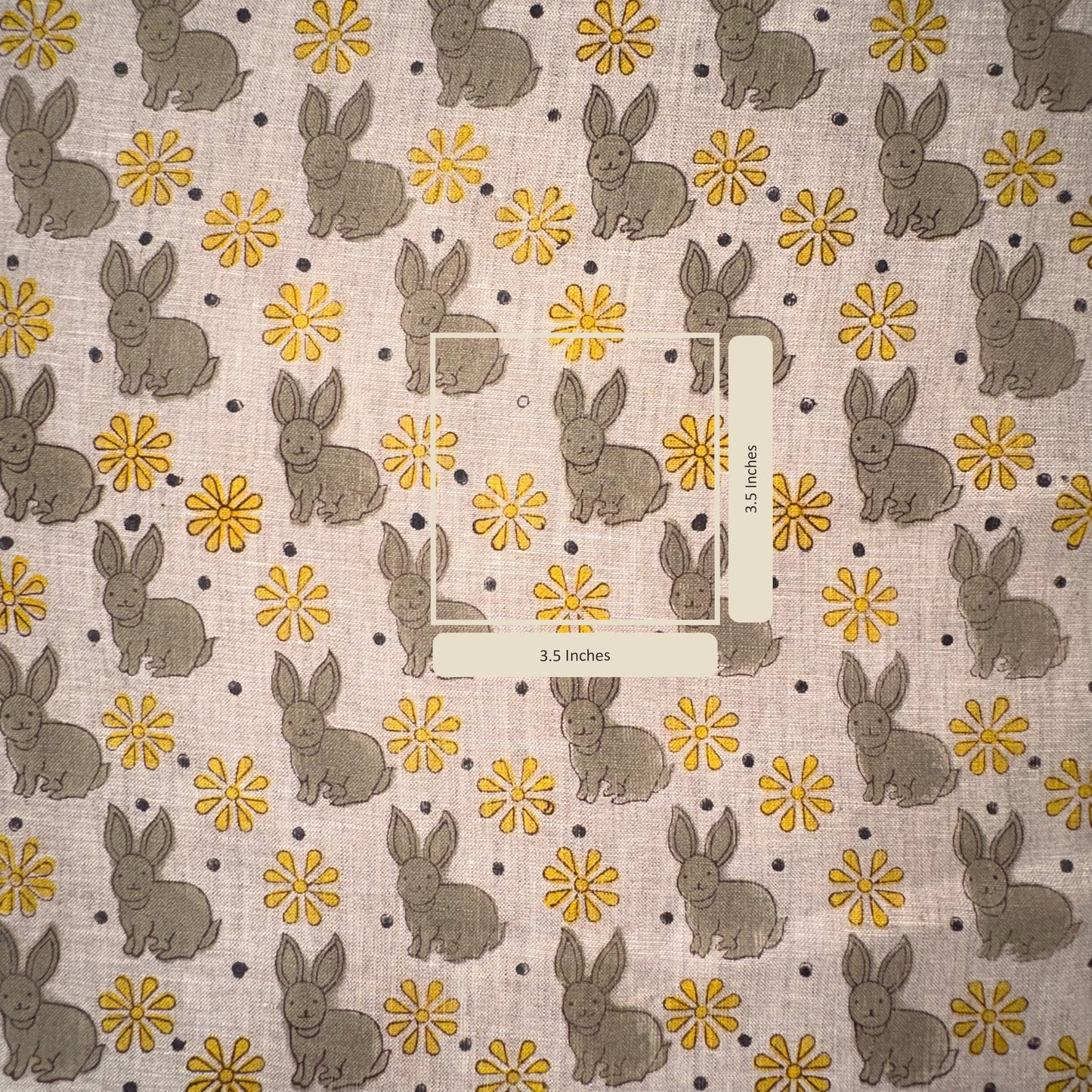 Fabric with bunny and flower pattern on a grey background