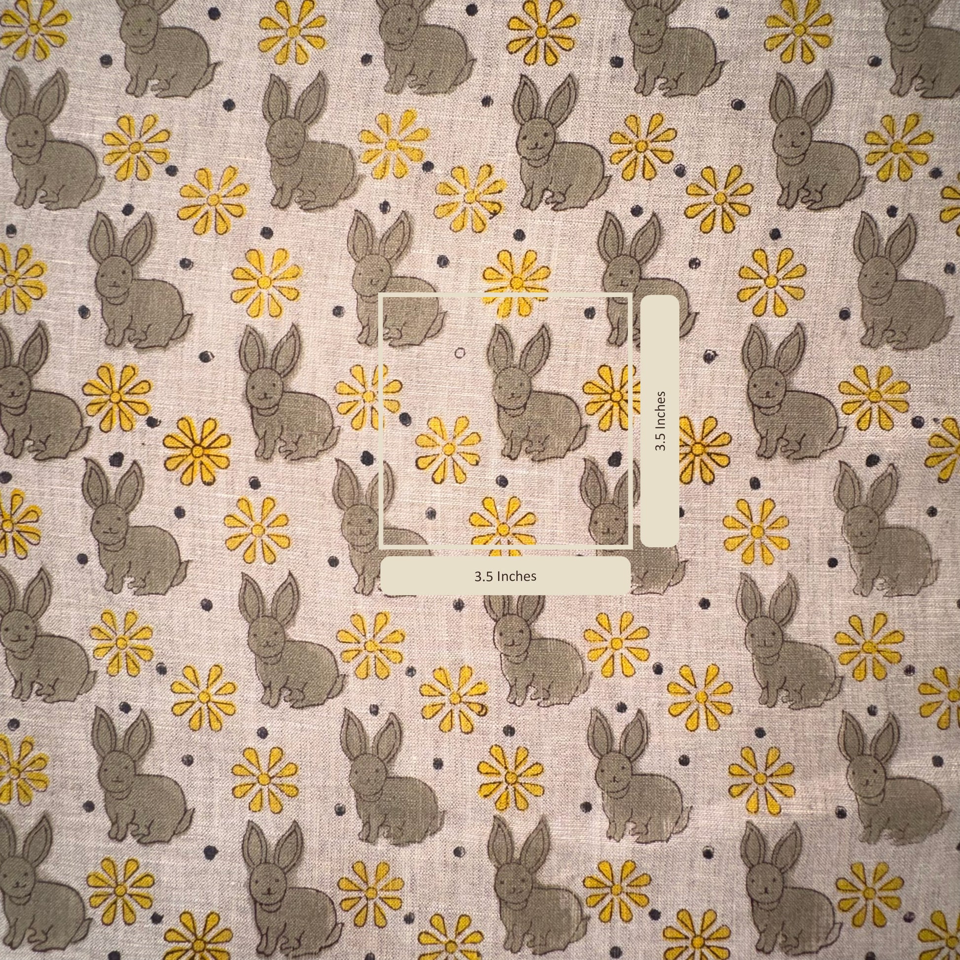 Fabric with bunny and flower pattern on a grey background